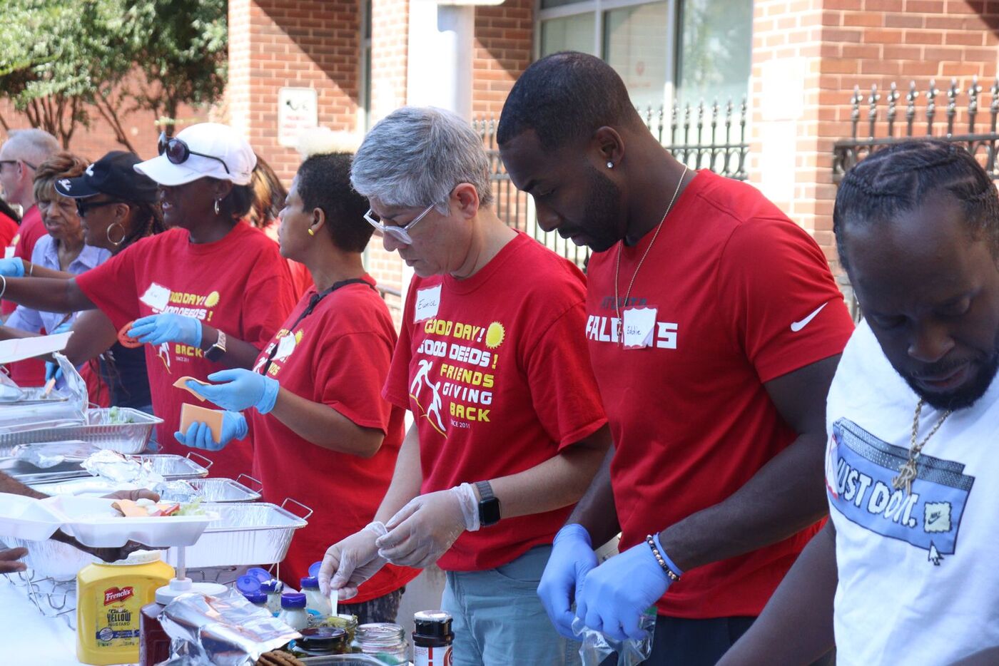 Eddie and Friends Giving Back volunteers prepping meals assembly-line style