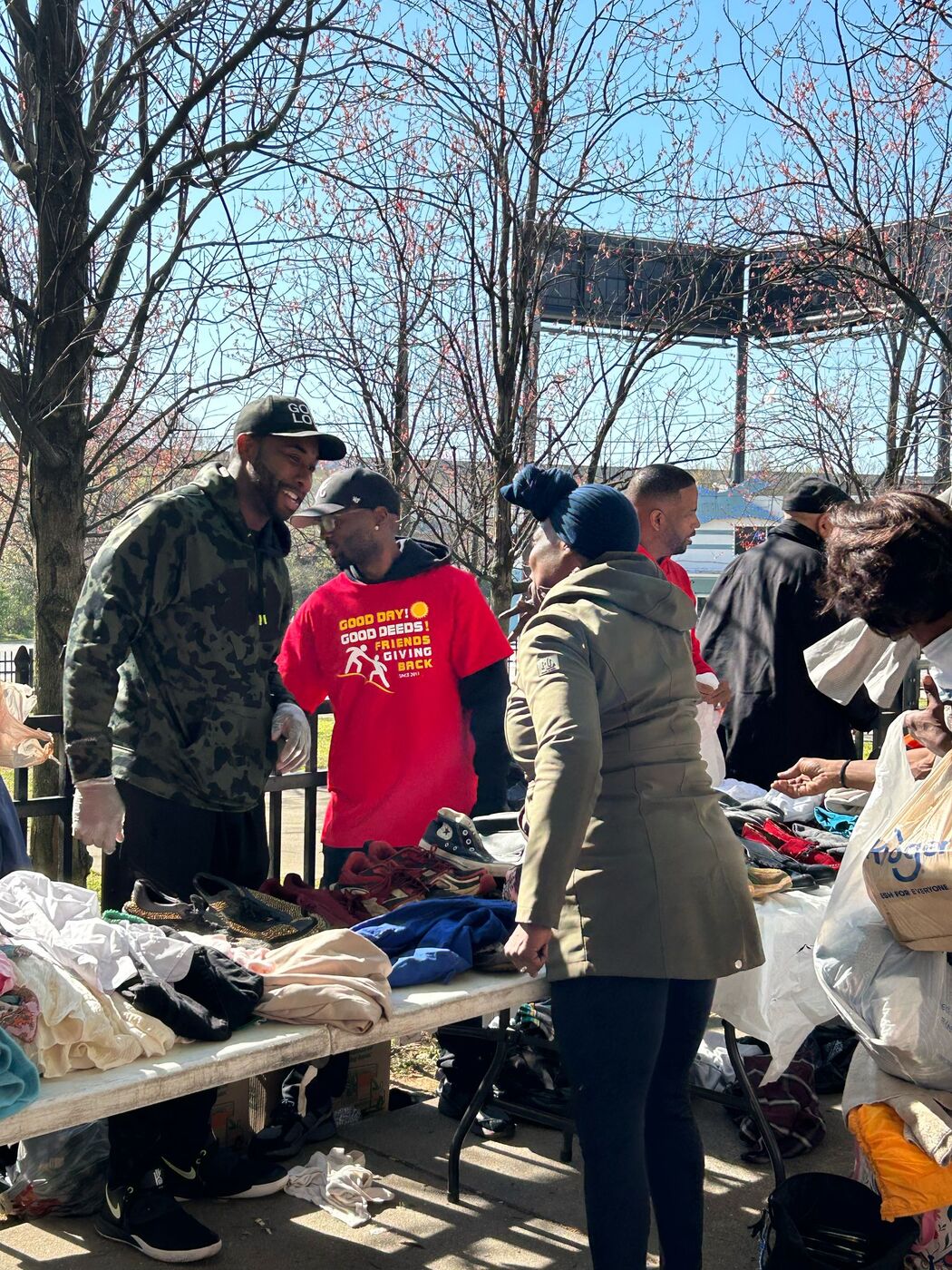 Volunteers sorting donated clothing on tables