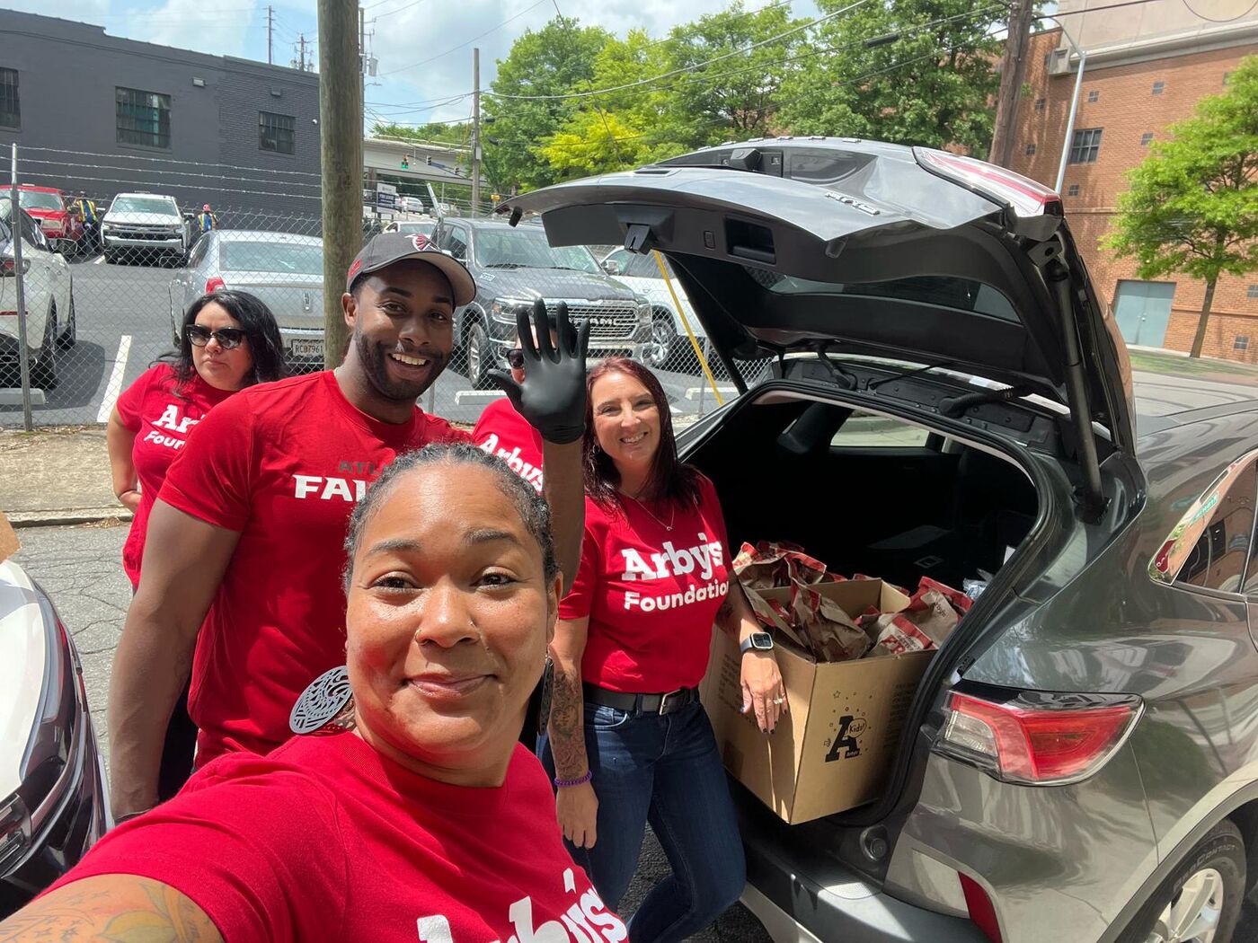 Boxes of donated food from the Arby's Foundation in a car trunk
