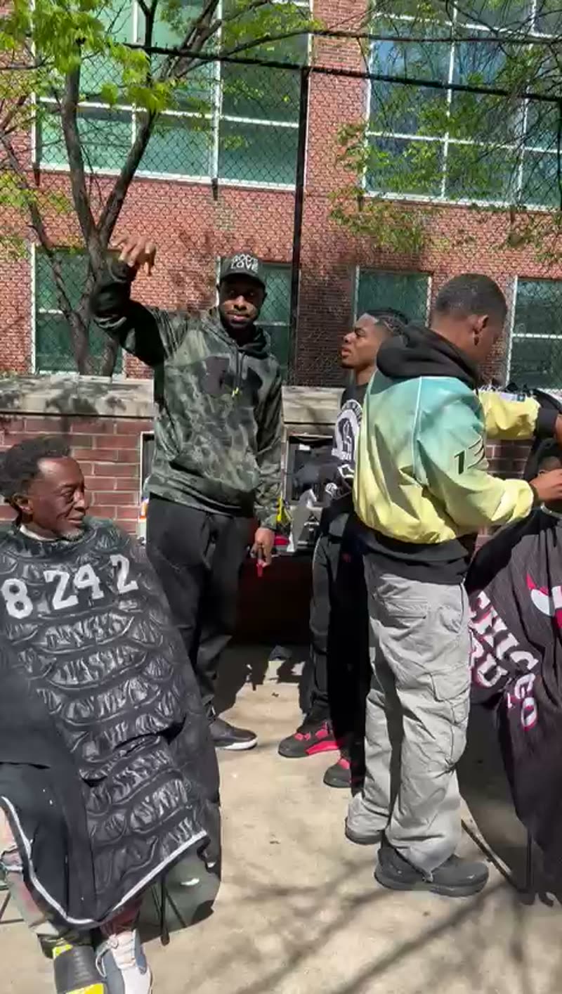 Video: barbers working through the line at a free haircut street event